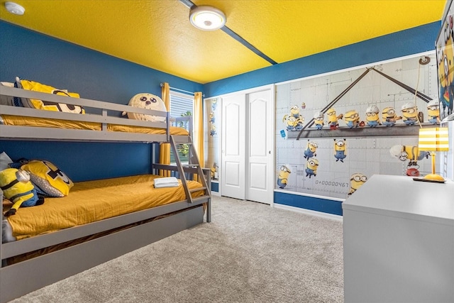 bedroom featuring light carpet and a closet