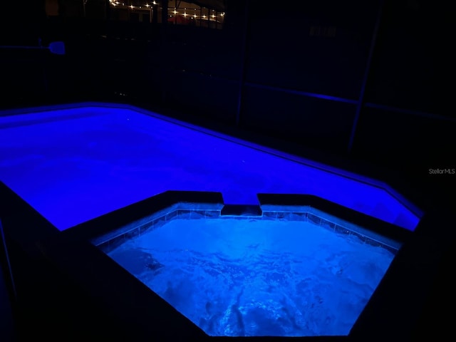 view of pool at night