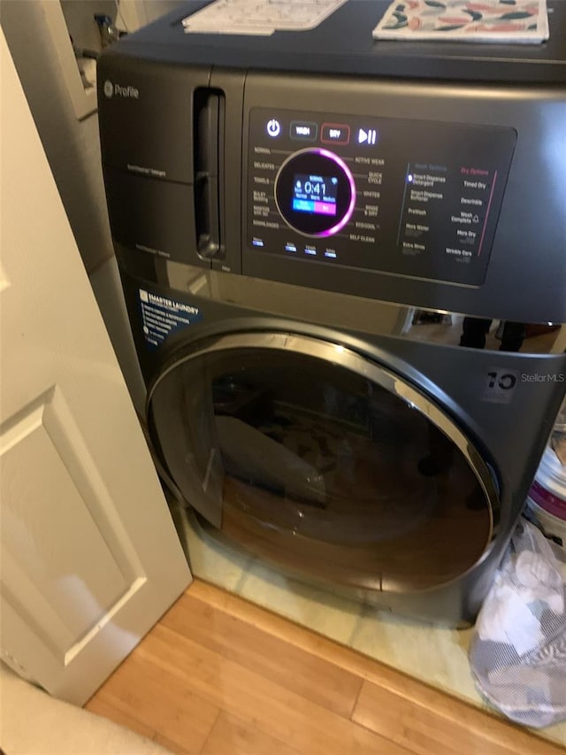 laundry area with hardwood / wood-style floors