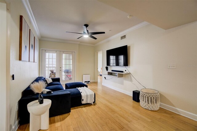 living room with ceiling fan, ornamental molding, light hardwood / wood-style flooring, and french doors