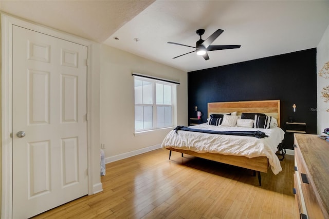 bedroom with ceiling fan and light hardwood / wood-style flooring