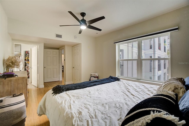 bedroom with a closet, ceiling fan, and light wood-type flooring