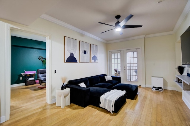 living room with ornamental molding, light hardwood / wood-style flooring, ceiling fan, and french doors