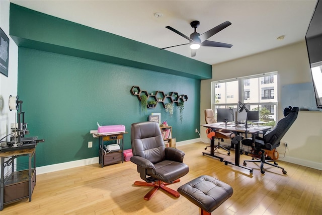 office with ceiling fan and light hardwood / wood-style floors