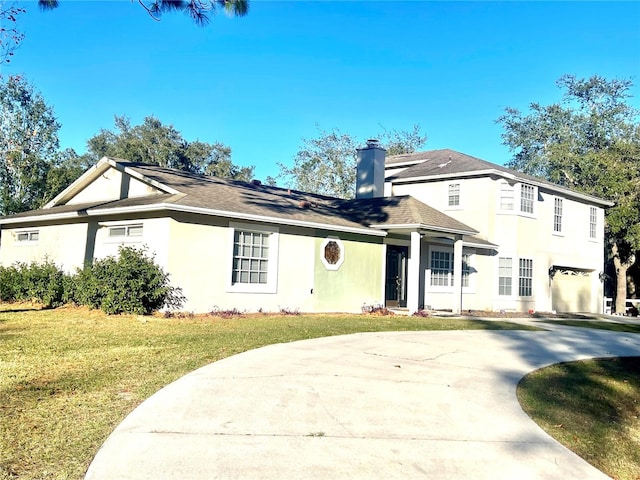 view of front of home featuring a garage and a front yard