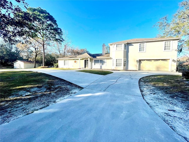 view of front of property with a garage and a front lawn