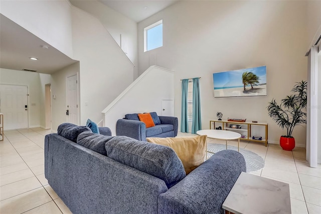 living room featuring light tile floors and a towering ceiling