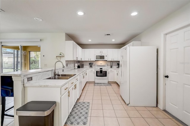 kitchen featuring white cabinetry, light tile floors, kitchen peninsula, white appliances, and sink