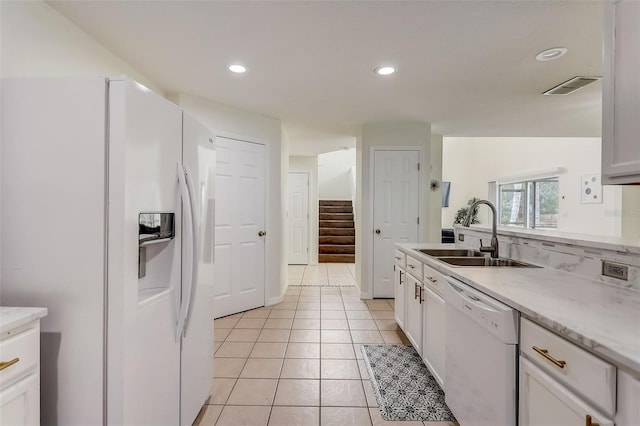 kitchen featuring white cabinetry, white appliances, sink, and light tile floors