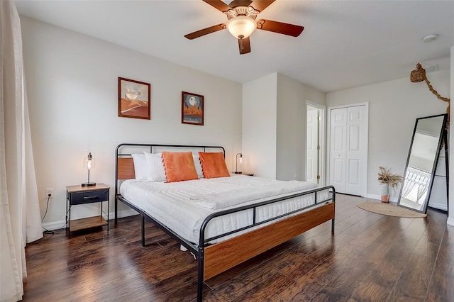 bedroom with ceiling fan, a closet, and dark wood-type flooring