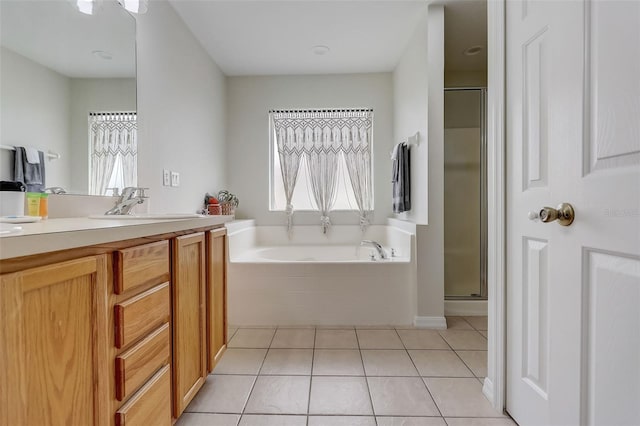 bathroom with tile floors, plus walk in shower, and vanity