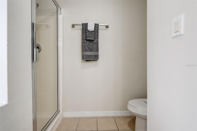 bathroom featuring toilet, tile flooring, and an enclosed shower