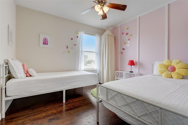 bedroom featuring dark hardwood / wood-style flooring and ceiling fan