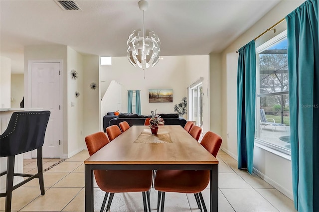 tiled dining room featuring a notable chandelier