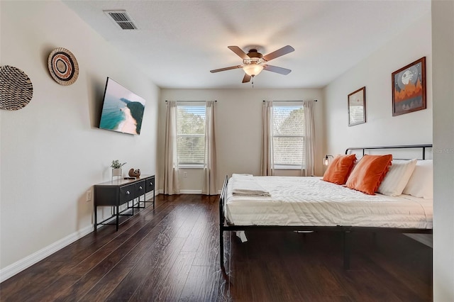 bedroom with ceiling fan and dark hardwood / wood-style flooring