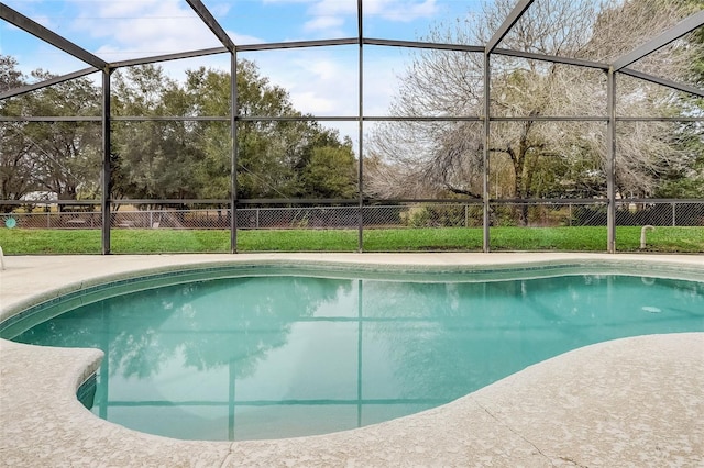 view of swimming pool featuring glass enclosure