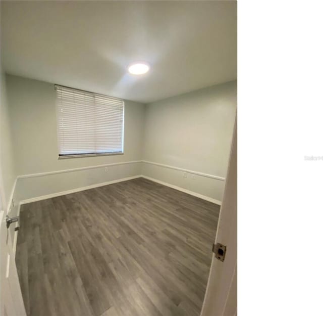 spare room featuring dark hardwood / wood-style floors