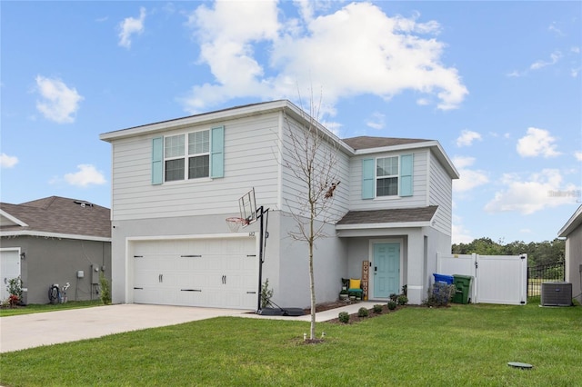 view of front of property with a front yard, central AC unit, and a garage