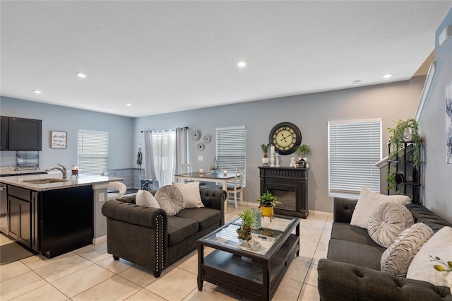 living room with sink and light tile patterned floors