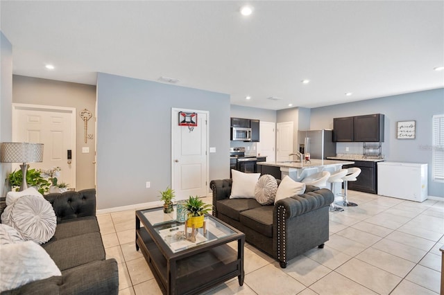 living room with sink and light tile patterned flooring