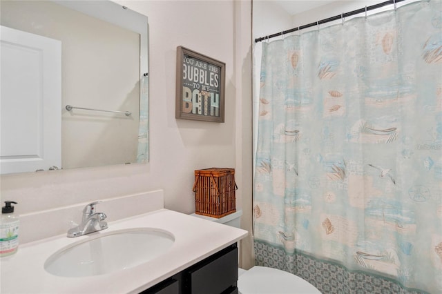 full bathroom with vanity, shower / bath combo, and toilet