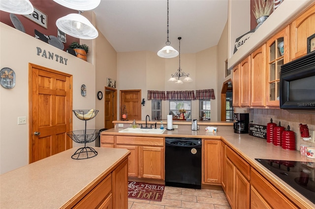 kitchen with backsplash, black appliances, sink, light tile floors, and pendant lighting