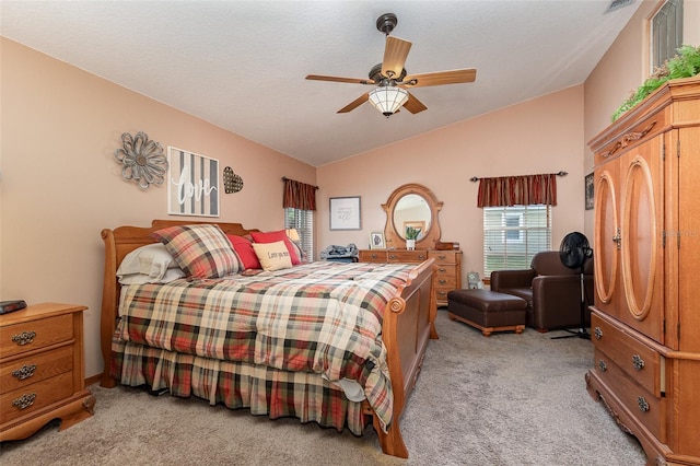 carpeted bedroom with lofted ceiling, ceiling fan, and a textured ceiling