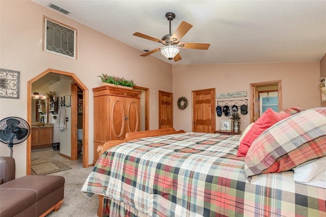 carpeted bedroom with lofted ceiling, ensuite bathroom, and ceiling fan