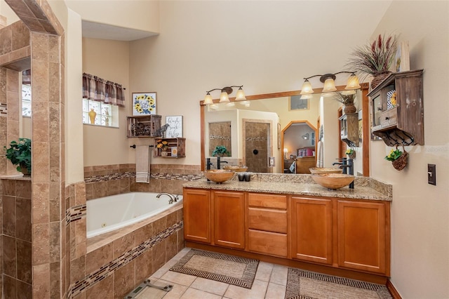 bathroom featuring tile floors, double vanity, and tiled bath