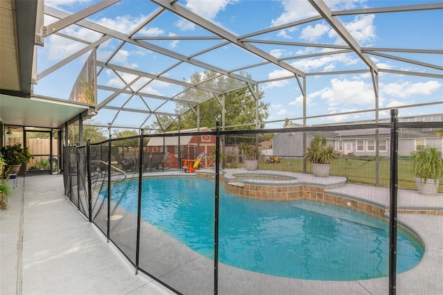 view of pool featuring a patio, an in ground hot tub, and glass enclosure