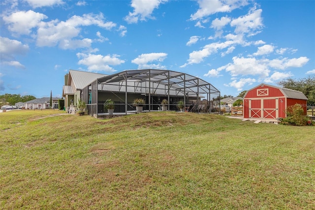 view of yard featuring a storage unit and glass enclosure