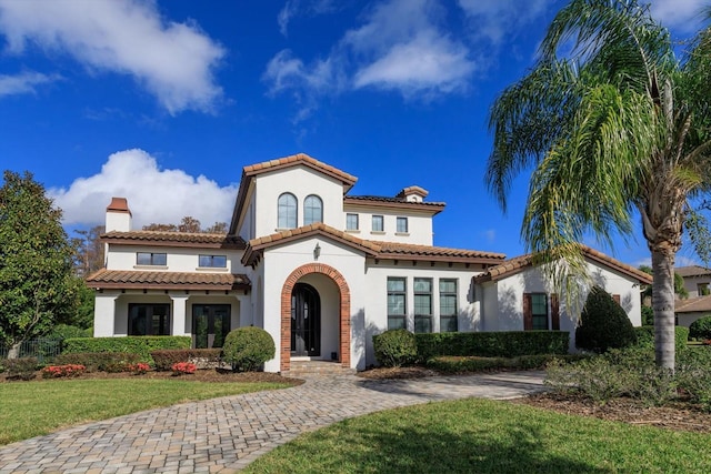 mediterranean / spanish house with a front yard