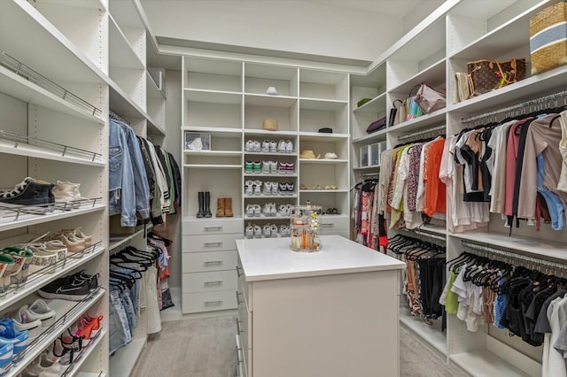 walk in closet featuring light colored carpet