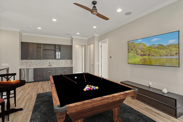 playroom with billiards, crown molding, ceiling fan, and light hardwood / wood-style flooring