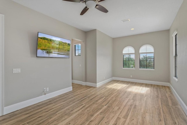 spare room featuring ceiling fan and light wood-type flooring