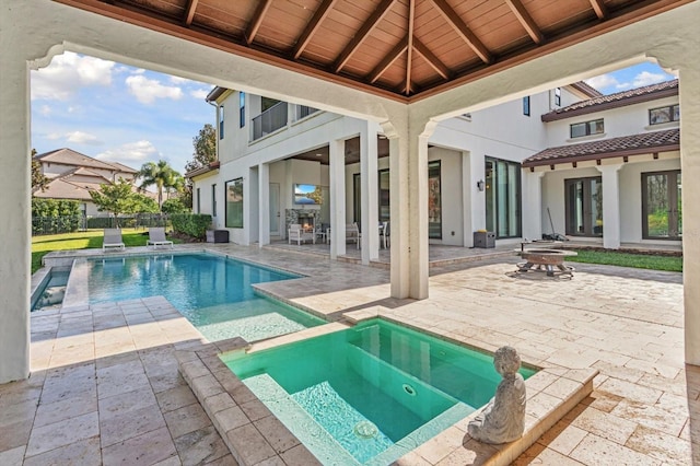 view of swimming pool with an in ground hot tub and a patio