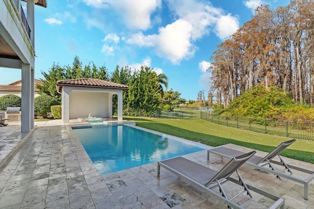 view of pool featuring a patio area and a yard