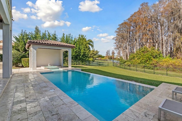 view of pool featuring a lawn and a patio