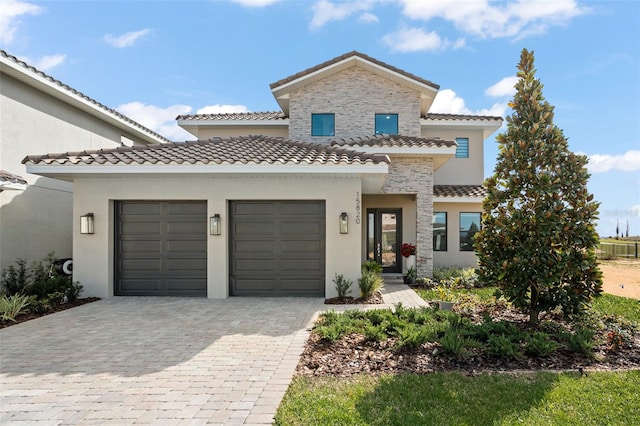 mediterranean / spanish home featuring a garage