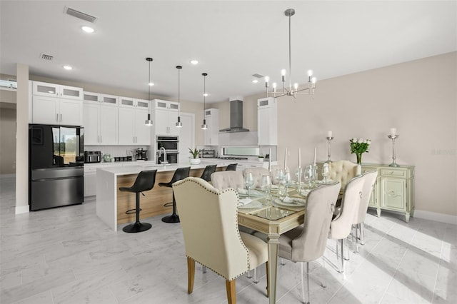 tiled dining room featuring a notable chandelier