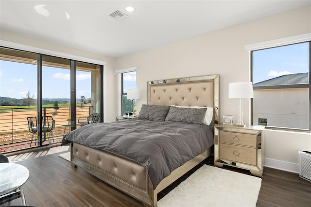 bedroom with dark hardwood / wood-style flooring and access to outside