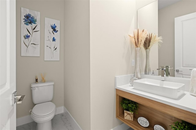 bathroom featuring tile floors, vanity with extensive cabinet space, and toilet