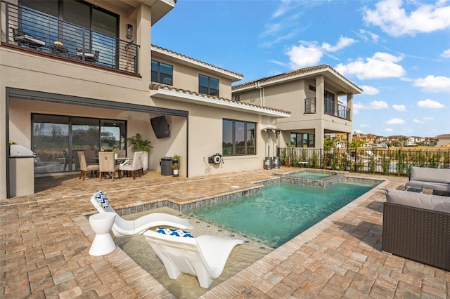 view of swimming pool featuring a patio area and an in ground hot tub