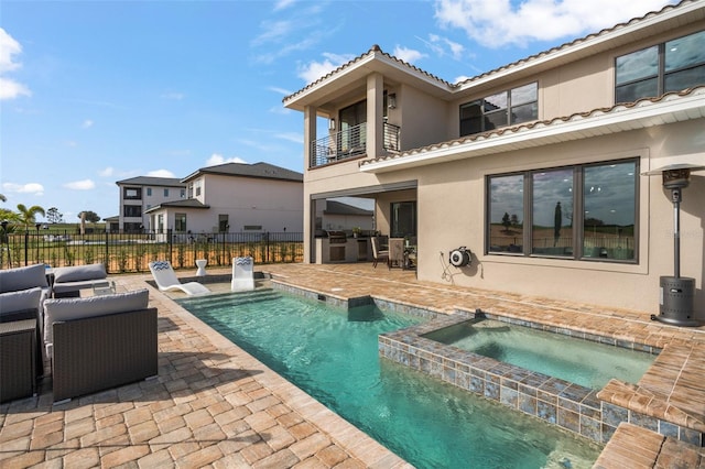 view of swimming pool with a patio and an in ground hot tub