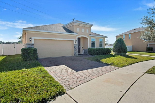 view of front of property with a garage and a front lawn