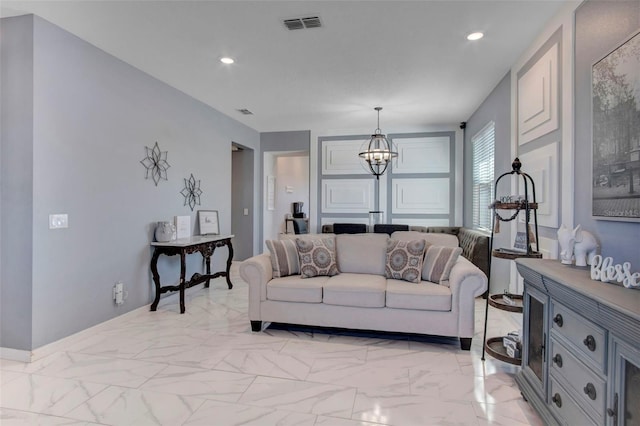 tiled living room featuring an inviting chandelier