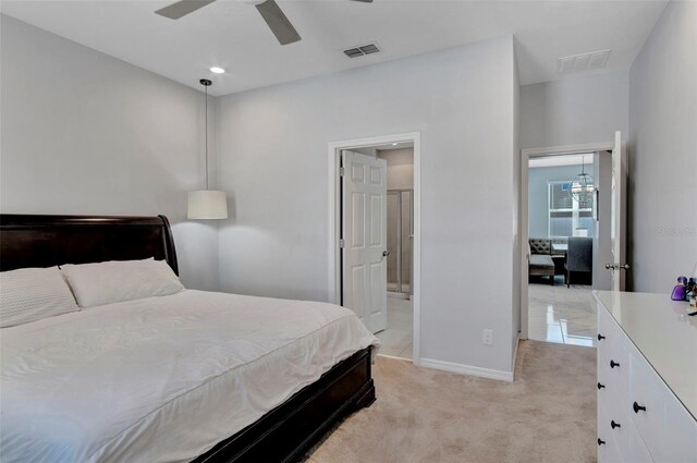 bedroom featuring ensuite bath, ceiling fan, and light tile flooring