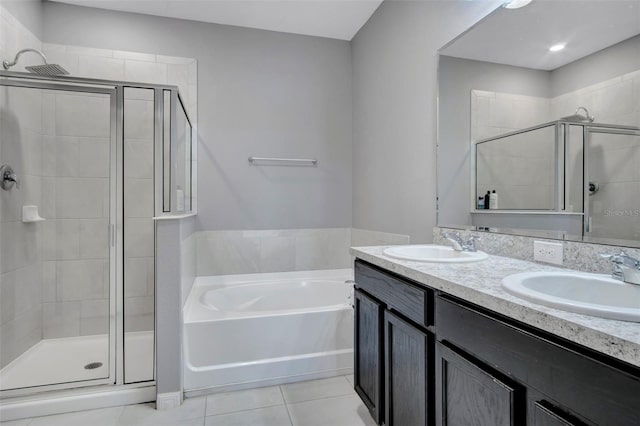 bathroom with shower with separate bathtub, tile flooring, dual sinks, and large vanity