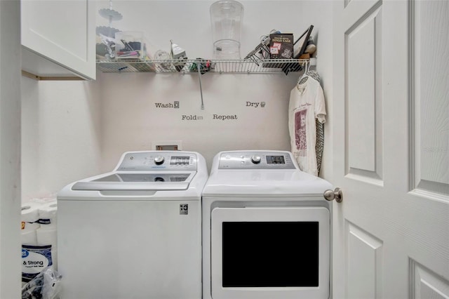 washroom with cabinets, washer and clothes dryer, and washer hookup