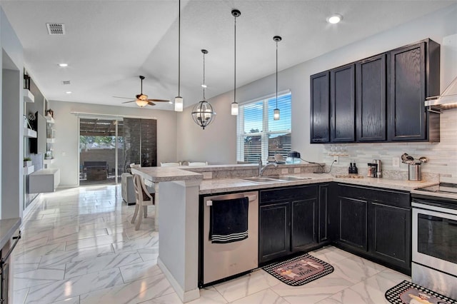 kitchen with ceiling fan, kitchen peninsula, pendant lighting, sink, and appliances with stainless steel finishes